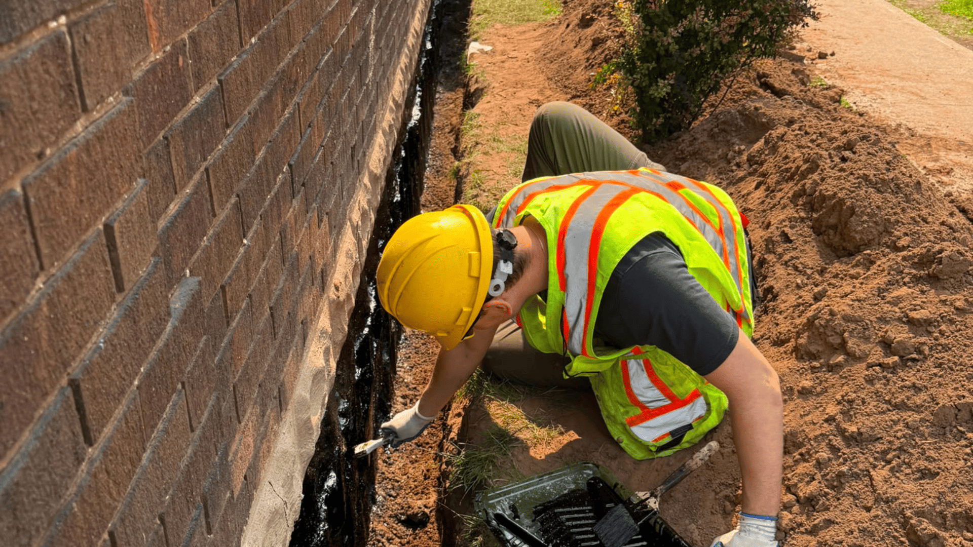 Black waterproof membrane applied to the foundation wall