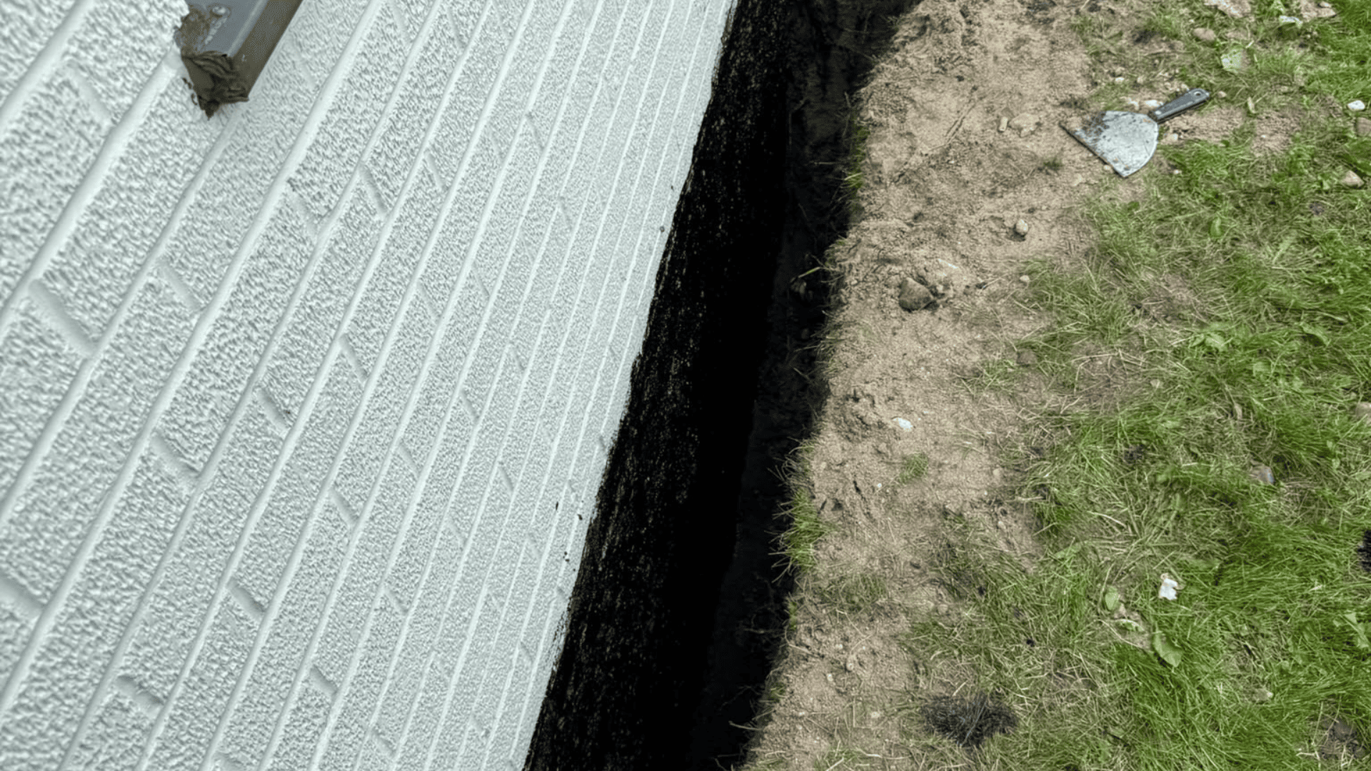 Waterproof membrane applied along the foundation